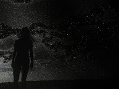 Silhouette of a person against a starry night sky